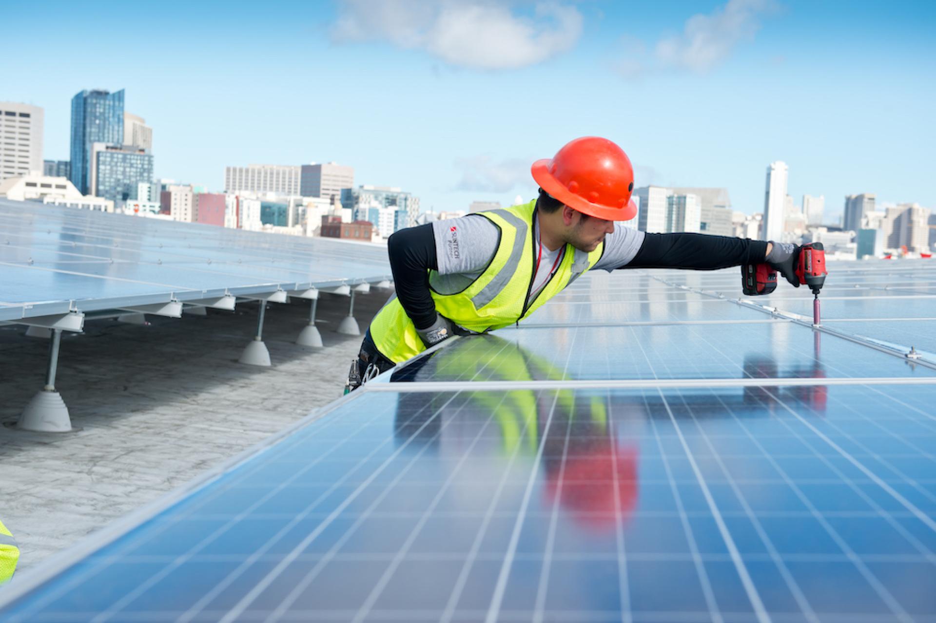 Technician installing solar panels