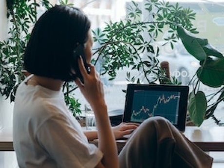 Woman looking at climate change graph on laptop